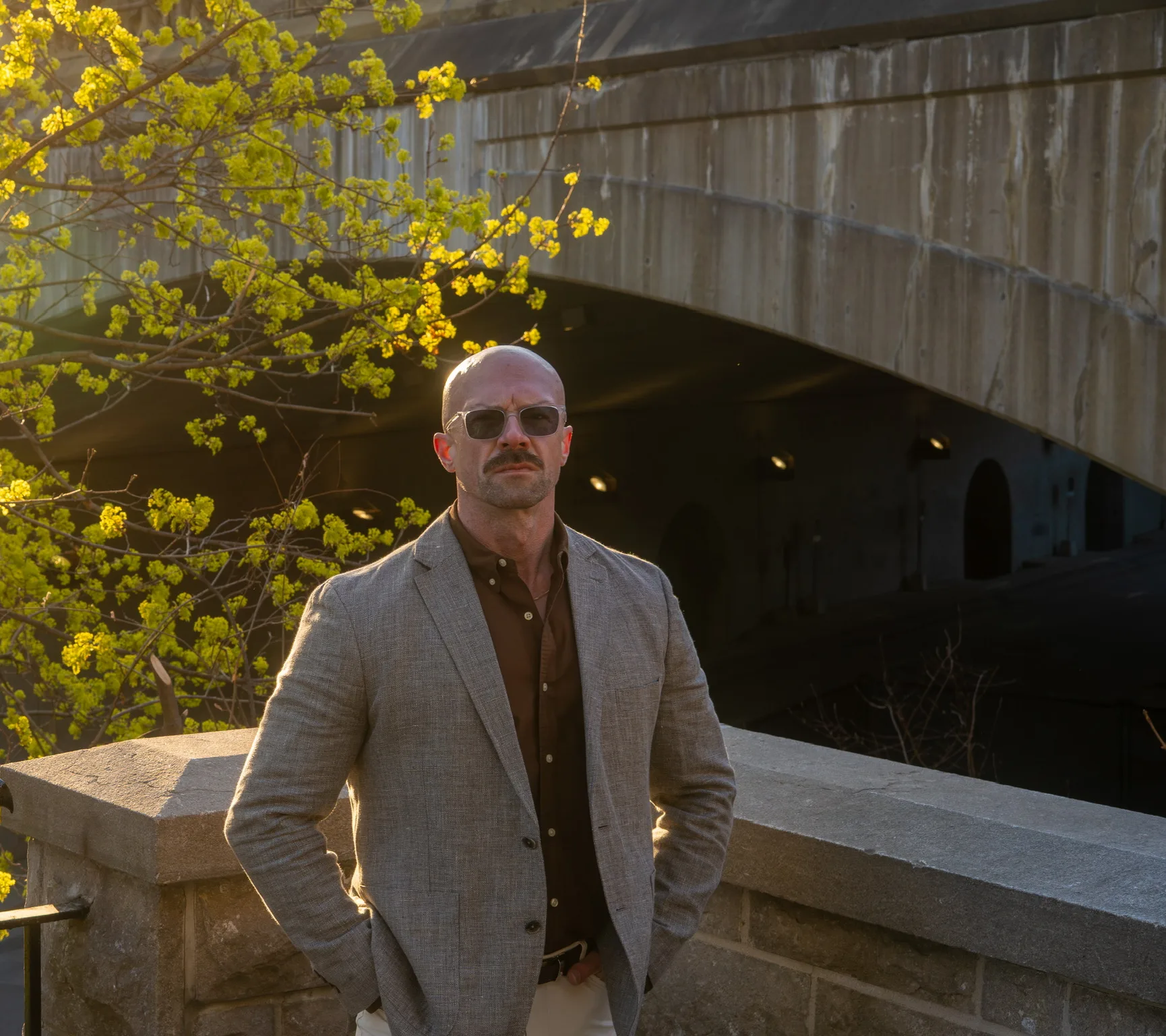 Tyson DesMarais at a stone bridge, looking straight at the camera
