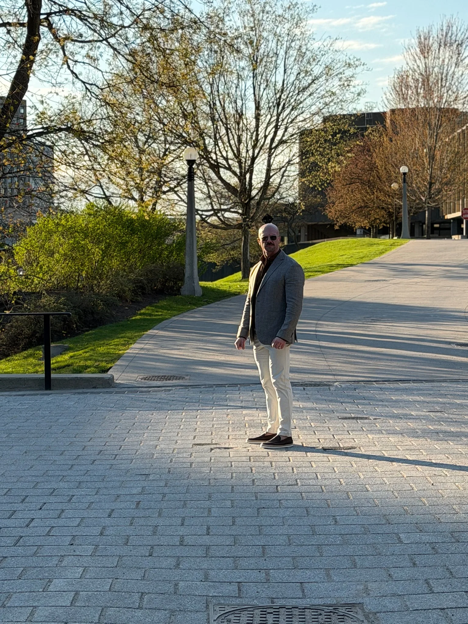Tyson DesMarais on a paved pathway at golden hour, turned toward you